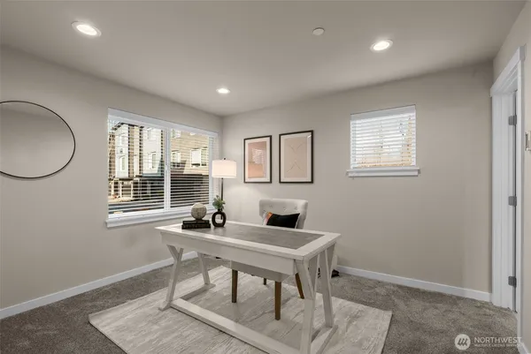 a work room with furniture and a window