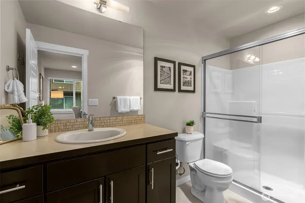 a bathroom with a sink toilet and a mirror