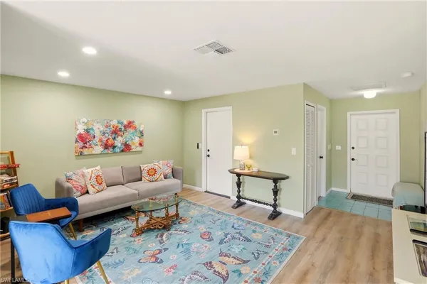 a living room with furniture and wooden floor