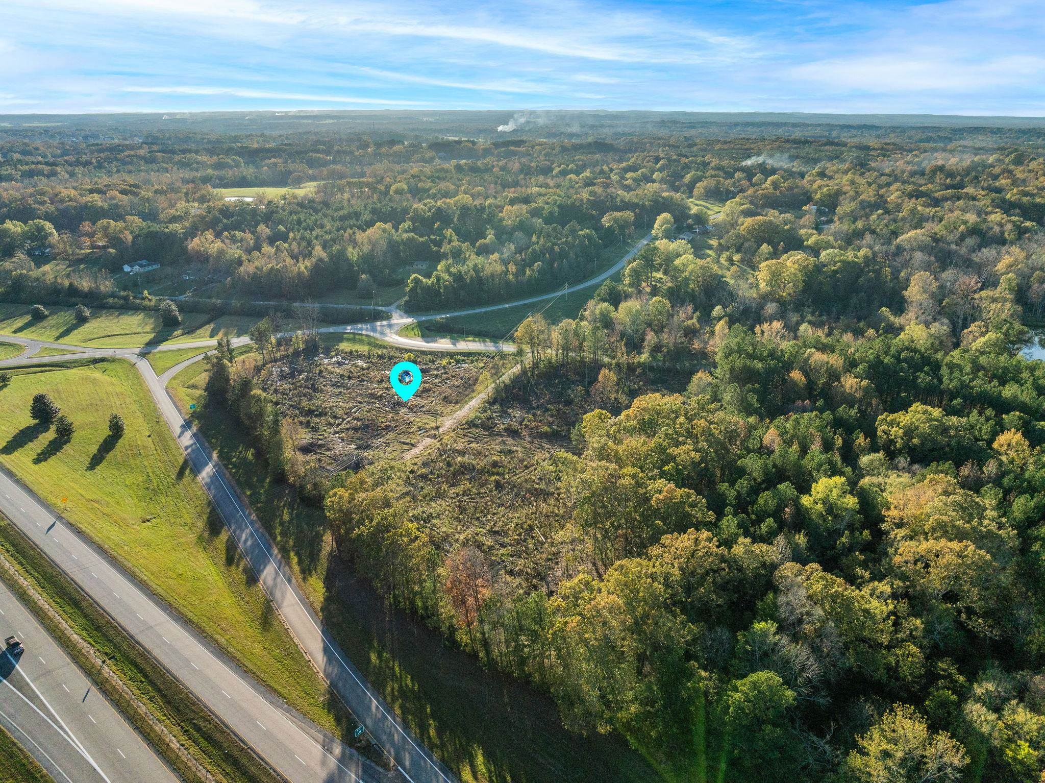 45 S Road Corinth, MS 38834 - Photo 11 of 34 Aerial view of property and surrounding area featuring a heavily wooded area