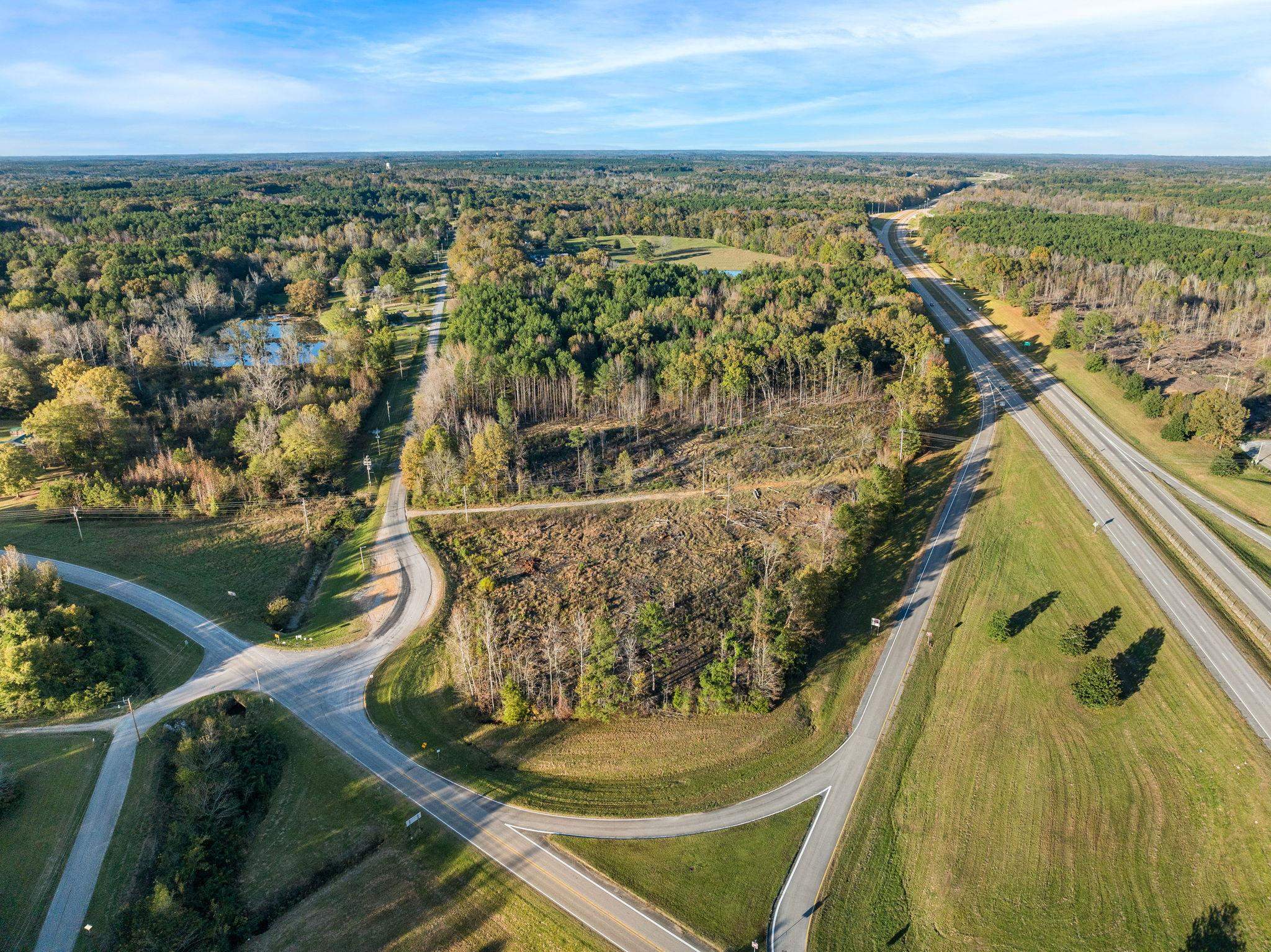 45 S Road Corinth, MS 38834 - Photo 4 of 34 Aerial view of property and surrounding area with a heavily wooded area