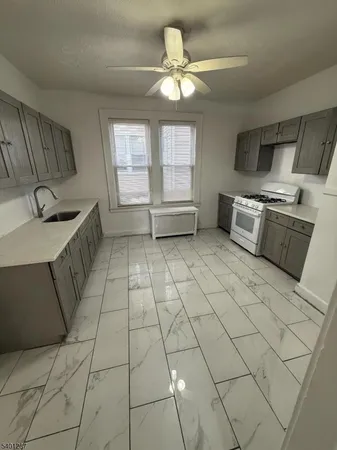 a kitchen with stainless steel appliances a sink a stove a microwave and cabinets