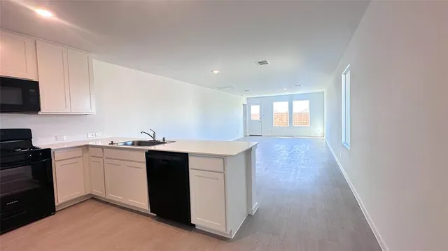 a kitchen with sink and cabinets