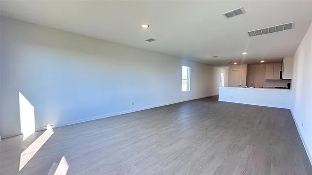 a kitchen with a refrigerator sink and cabinets