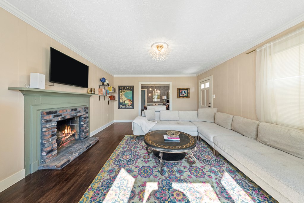 7047 Mellwood Road Columbus, GA 31904 - Photo 15 of 34 a living room with furniture and a fireplace