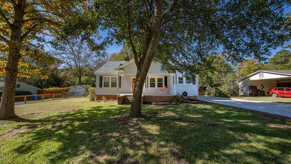 7047 Mellwood Road Columbus, GA 31904 - Photo 2 of 34 a view of a yard with a house and a tree