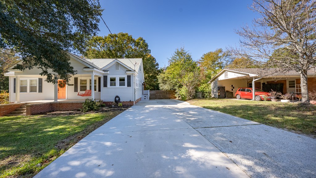 7047 Mellwood Road Columbus, GA 31904 - Photo 3 of 34 a front view of a house with a yard and trees