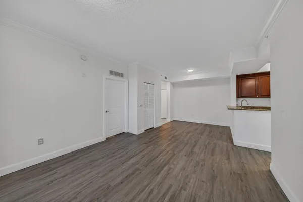a view of empty room with wooden floor and fireplace