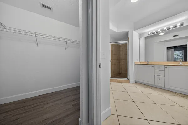 a view of a hallway with closet and wooden floor
