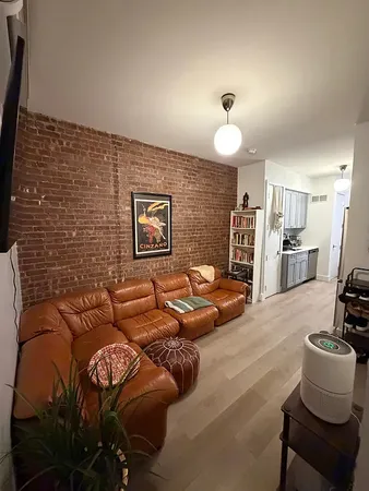 a view of a kitchen with refrigerator and a sink