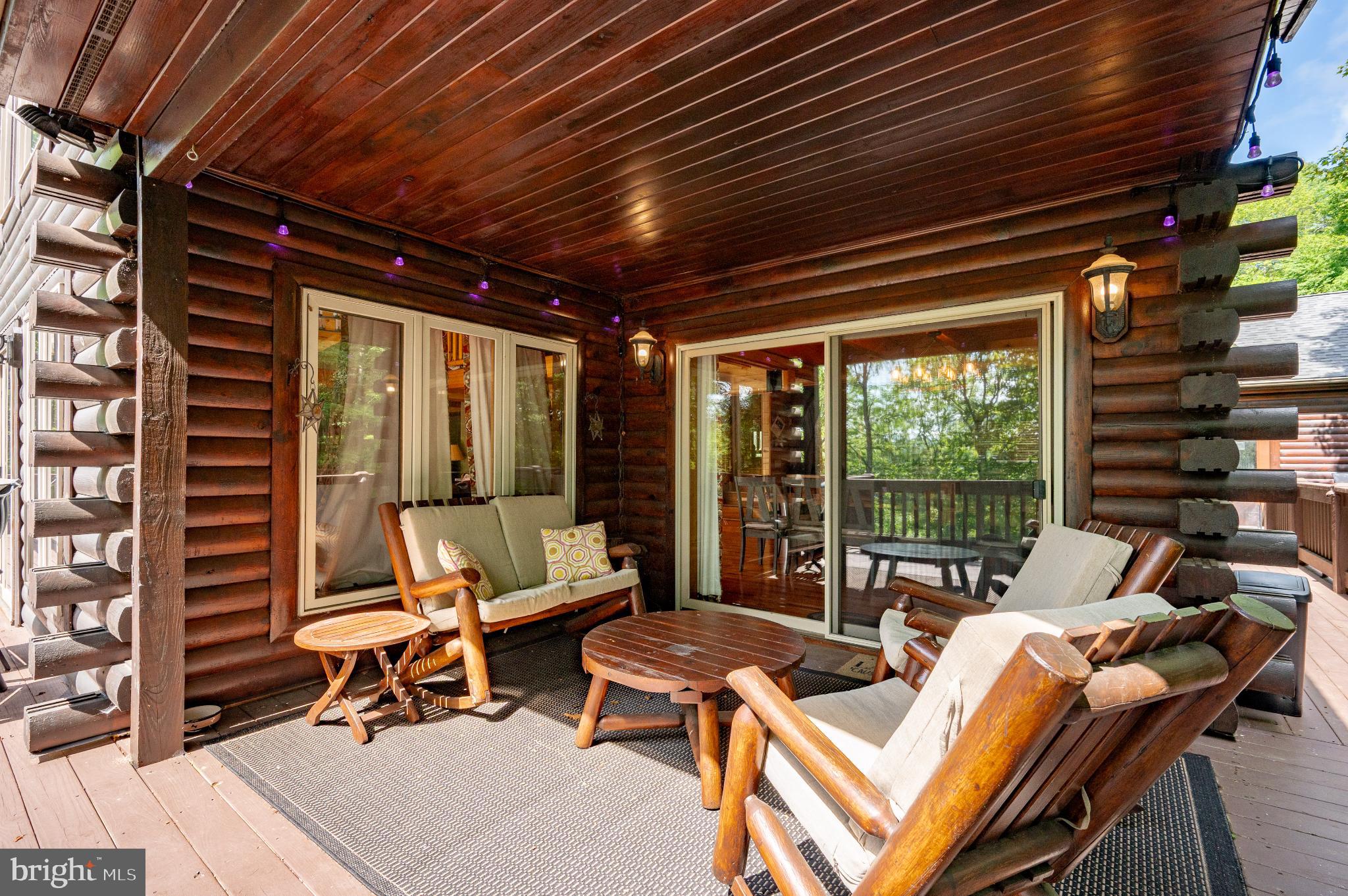 615 Sandy Shores Road Oakland, MD 21550 - Photo 84 of 103 Charming log cabin porch with serene views.