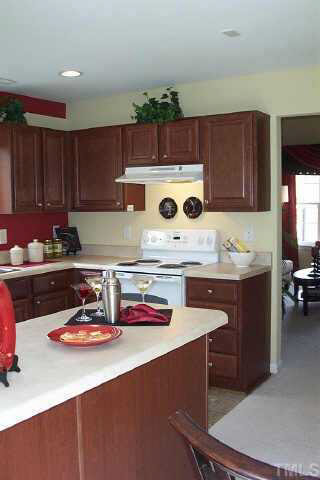 7831 Averette Hill Drive Raleigh, NC 27616 - Photo 3 of 10 a kitchen with a sink a stove and cabinets