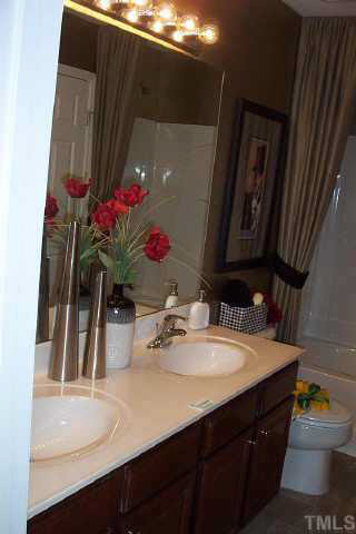 7831 Averette Hill Drive Raleigh, NC 27616 - Photo 5 of 10 a bathroom with a sink and a mirror