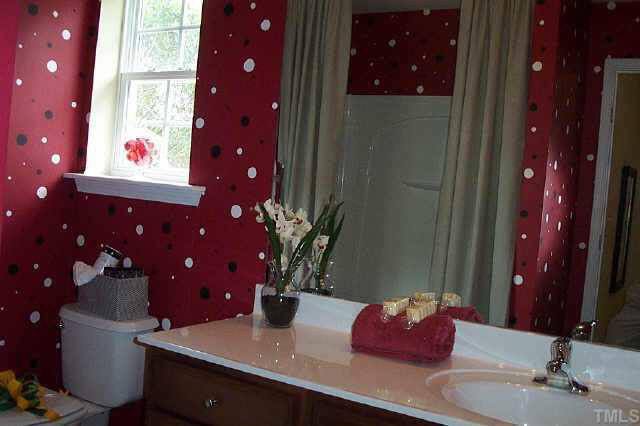 7831 Averette Hill Drive Raleigh, NC 27616 - Photo 6 of 10 a bathroom with a sink vanity and a mirror