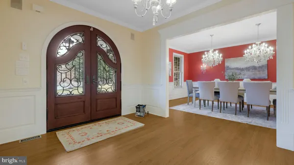 a large kitchen with granite countertop a large counter top cabinets and stainless steel appliances