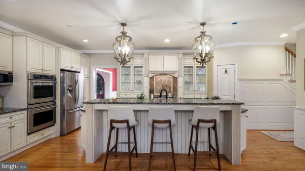 a view of a dining room with furniture and chandelier