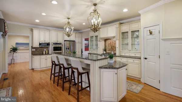 a view of a dining room with furniture wooden floor and chandelier