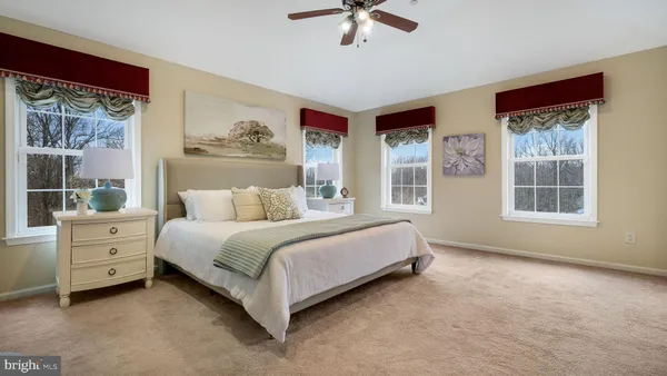 a bedroom with a bed and a painting on the wall