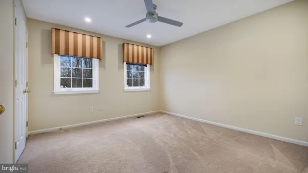 a living room with furniture a chandelier and a rug