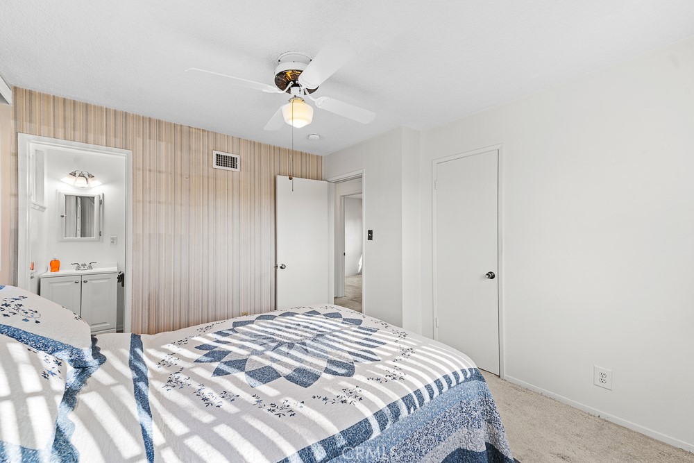 10282 Longden Street Cypress, CA 90630 - Photo 22 of 43 a bedroom with a bed and a chandelier