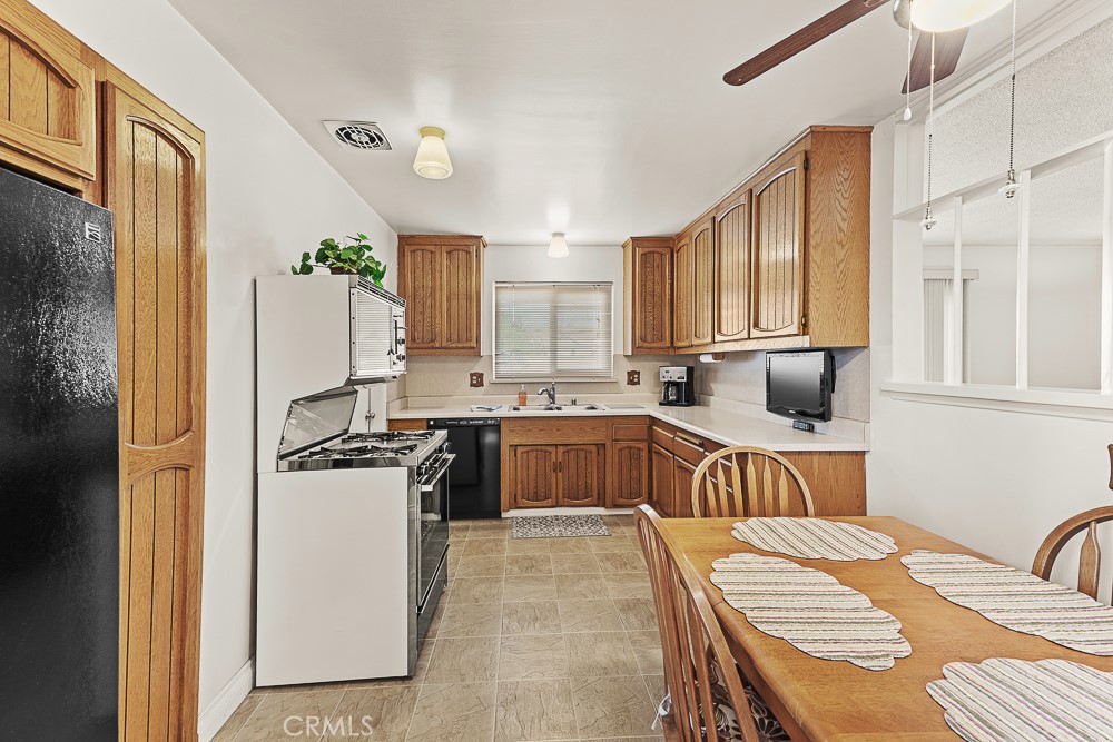 10282 Longden Street Cypress, CA 90630 - Photo 36 of 43 a kitchen with a refrigerator and a stove top oven