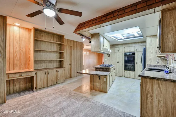 a kitchen with stainless steel appliances kitchen island granite countertop a table and chairs in it