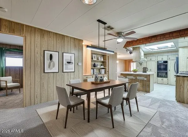 a dining room with furniture and window