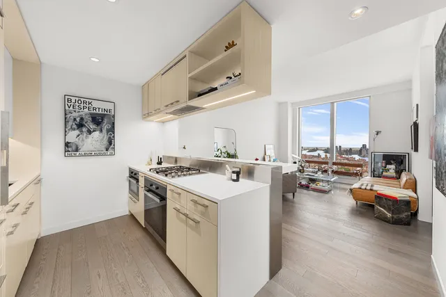 a kitchen with stainless steel appliances a sink stove and cabinets