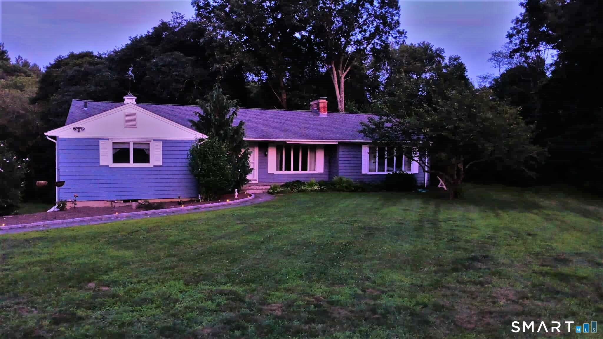 a front view of a house with a garden