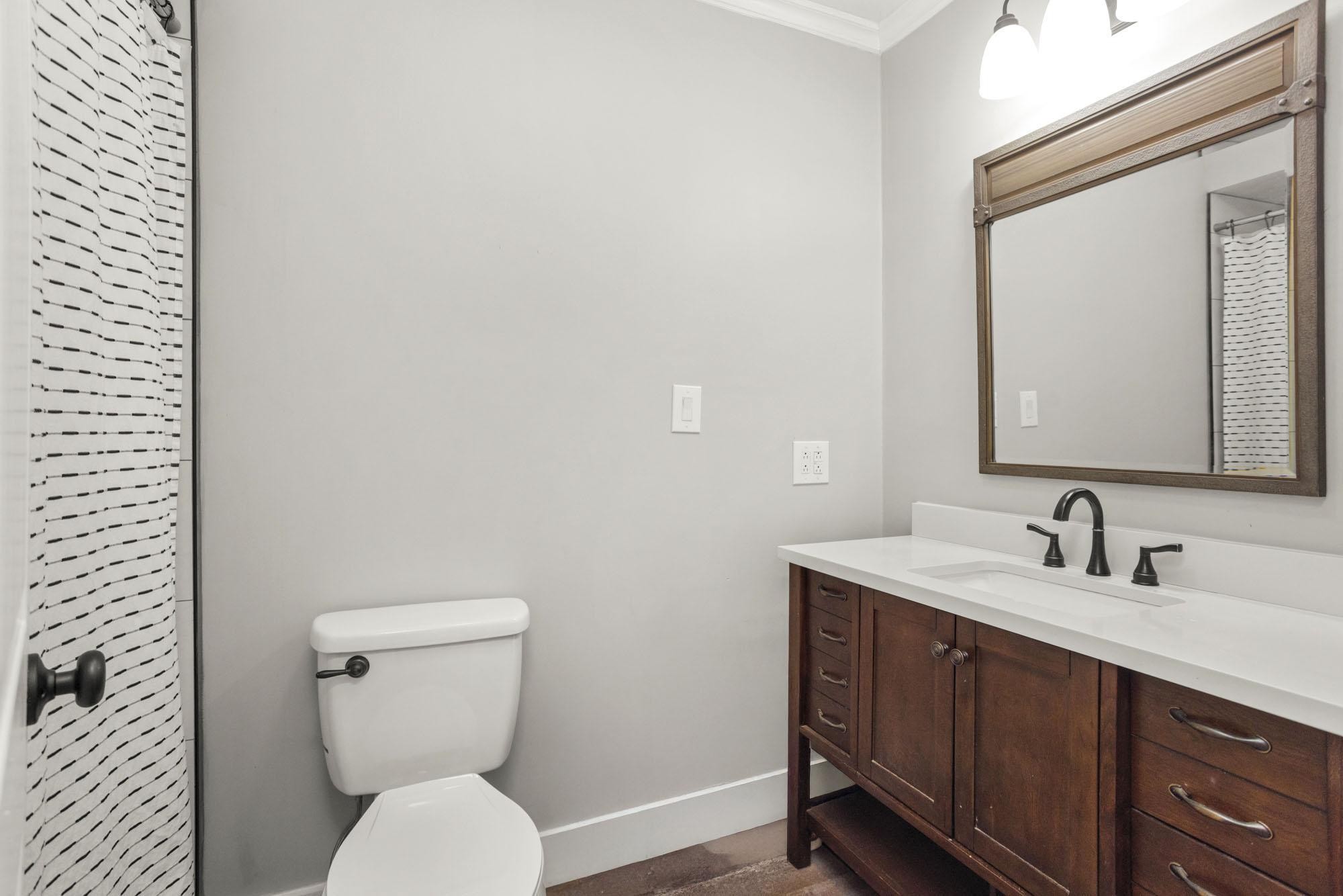 1300 Ridge Road Dickson, TN 37055 - Photo 13 of 60 a bathroom with a toilet a sink and mirror