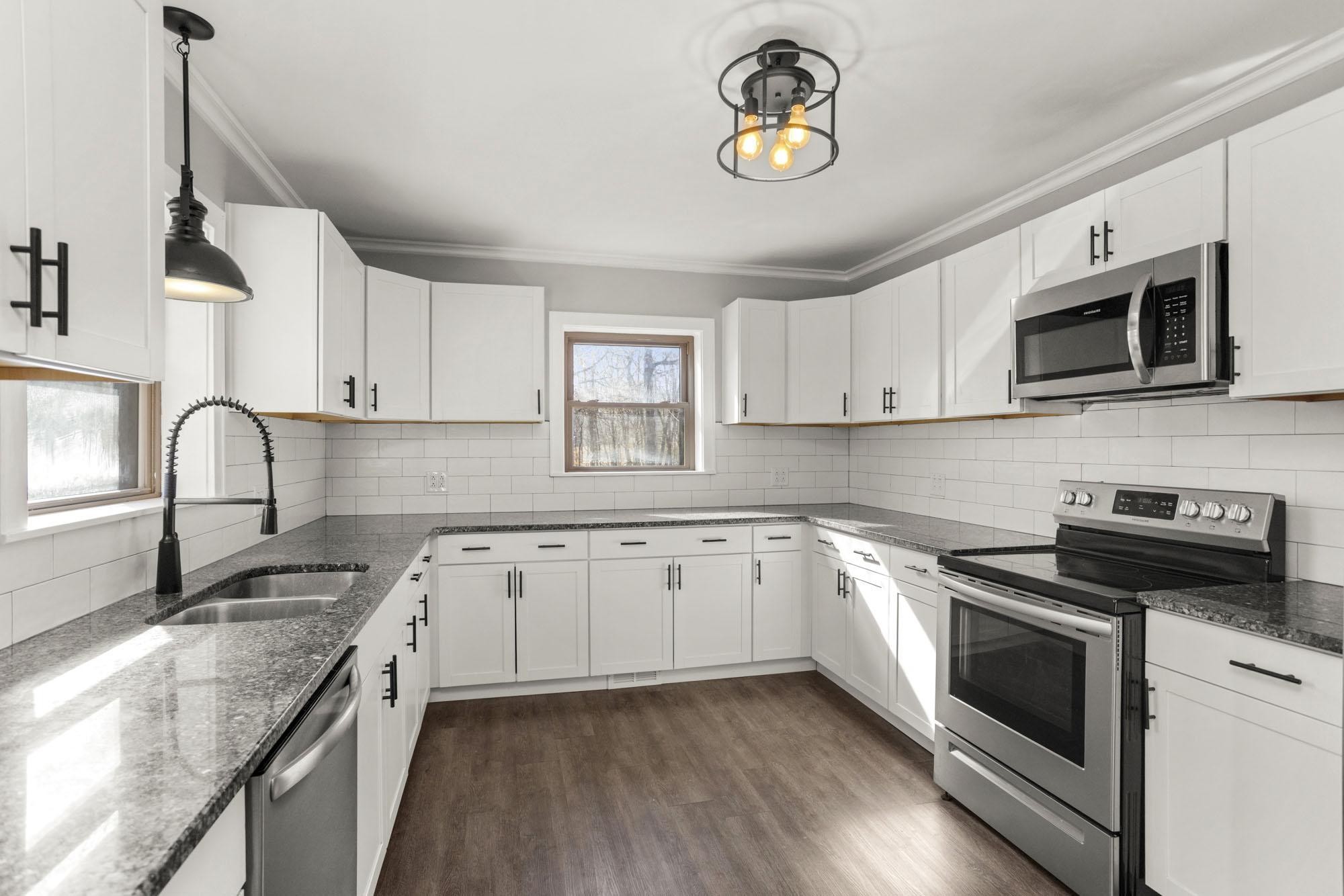 1300 Ridge Road Dickson, TN 37055 - Photo 24 of 60 a kitchen with granite countertop cabinets stainless steel appliances and a sink
