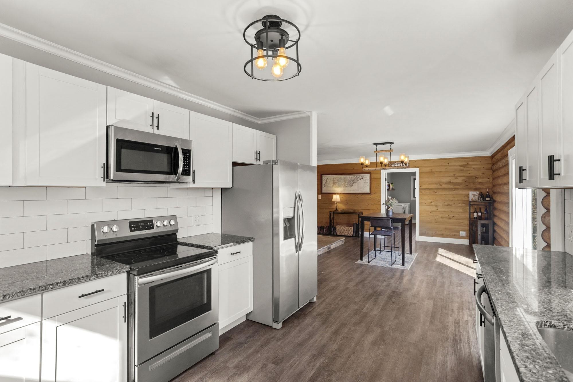 1300 Ridge Road Dickson, TN 37055 - Photo 26 of 60 a kitchen with stainless steel appliances a stove microwave and a refrigerator