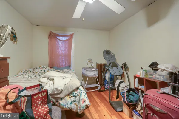 a bedroom with furniture and a wooden floor