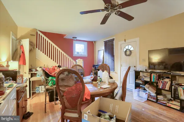 a dining room with furniture a rug and wooden floor