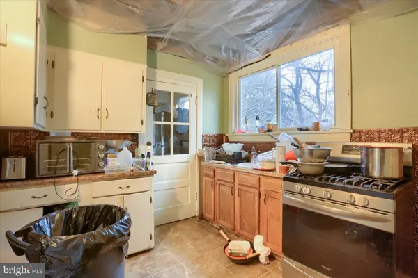 a kitchen with a sink stove and cabinets