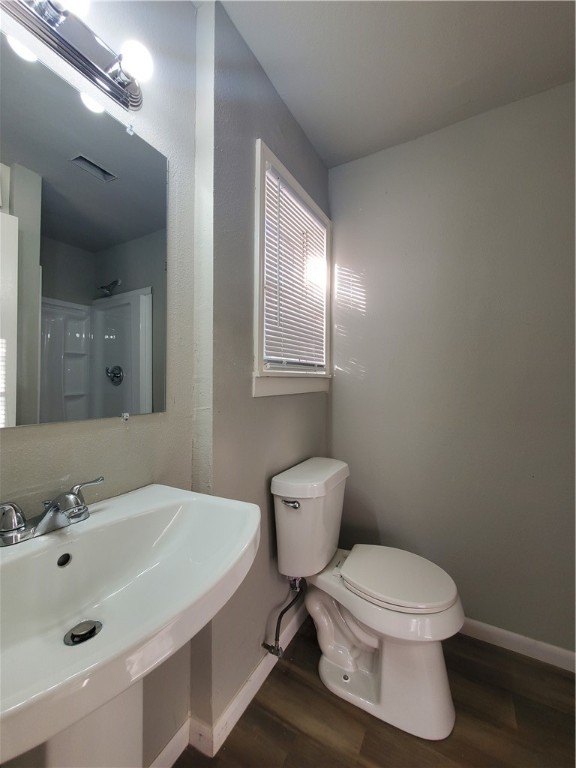 3605 Poplar Street Corpus Christi, TX 78411 - Photo 11 of 11 a bathroom with a sink a toilet and mirror