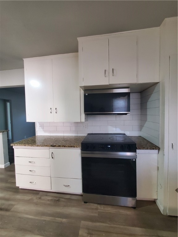 3605 Poplar Street Corpus Christi, TX 78411 - Photo 4 of 11 a kitchen with granite countertop white cabinets stainless steel appliances and wooden floor