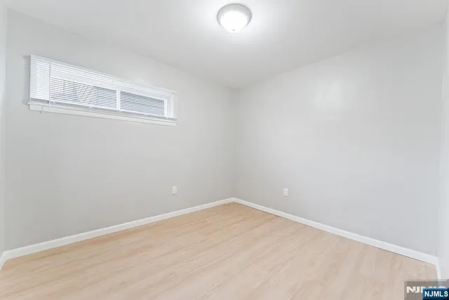 a view of a room with wooden floor and windows