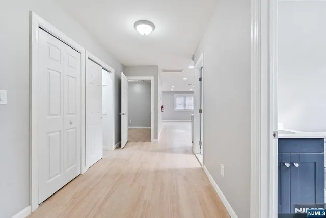 a view of a hallway with wooden floor