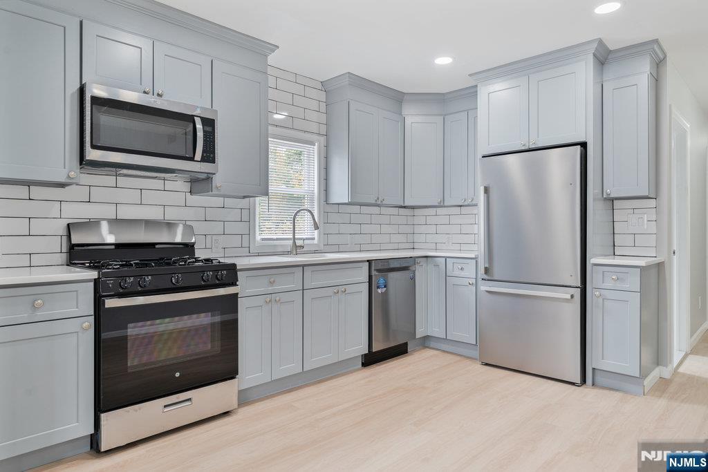 16 John Street, Unit 2 Lodi, NJ 07644 - Photo 26 of 32 a kitchen with cabinets stainless steel appliances and a counter space