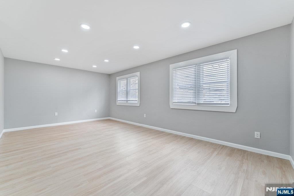 16 John Street, Unit 2 Lodi, NJ 07644 - Photo 28 of 32 a view of an empty room with wooden floor and a window