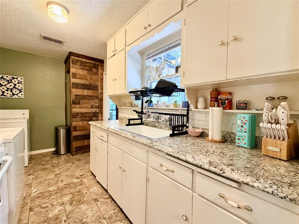919 Denton Street Denton, TX 76201 - Photo 7 of 19 a kitchen with sink and cabinets