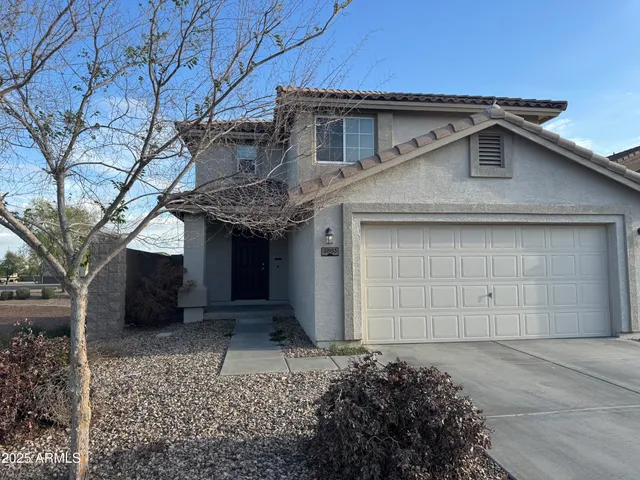 a front view of a house with a yard and garage