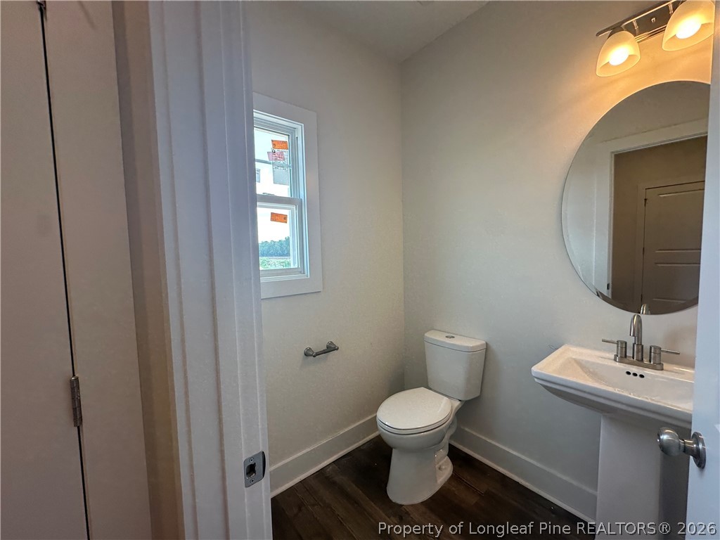 8383 Shannon Road Shannon, NC 28386 - Photo 9 of 17 a bathroom with a toilet sink and mirror
