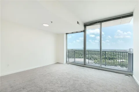 a view of an empty room with windows