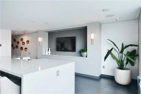 a bathroom with a sink a potted plant and a window