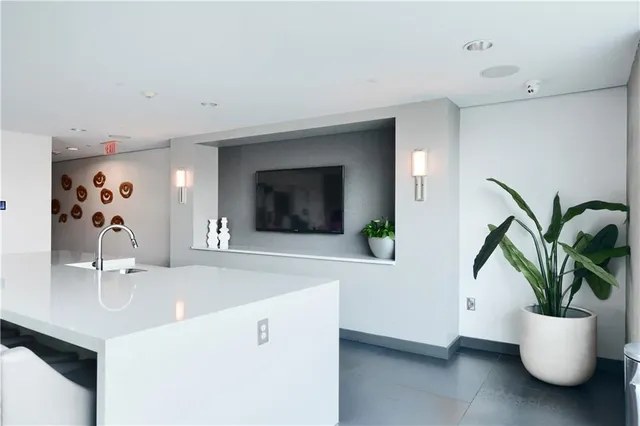 a bathroom with a sink a potted plant and a window