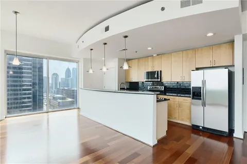 a kitchen with stainless steel appliances a refrigerator a sink a stove a microwave and island