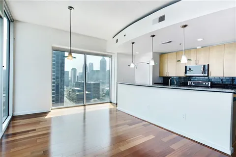 a view of a kitchen with large windows