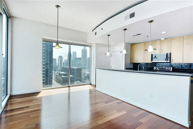 a view of a kitchen with large windows
